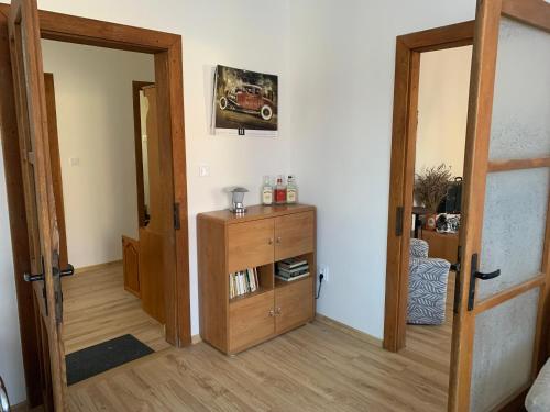 a room with an open door and a wooden cabinet at Dovolenkový dom v centre in Slovenská ľupča