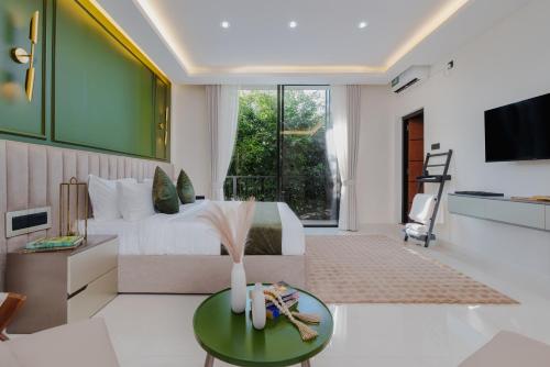 a bedroom with a bed and a living room at Orbit88 Hotel by AMR in Kandy