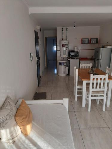 a living room with a white couch and a table at Ayres Apart in Chivilcoy
