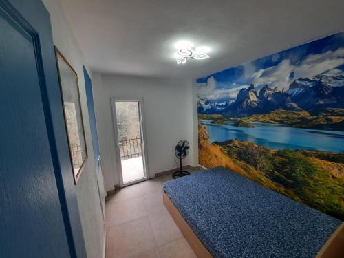 a bedroom with a mural of a lake and mountains at "Blue Villa" with private pool,BBQ in Andora in Moltedo