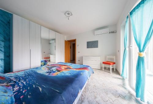 a bedroom with a large blue bed in a room at Bosa Mare & Relax in Bosa Marina