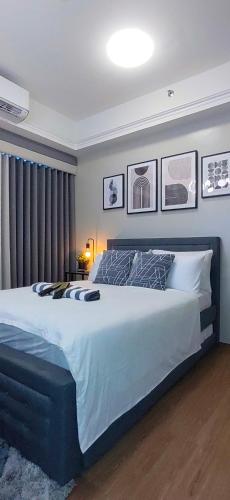a bedroom with a large bed in a room at Santorini Condotel in Manila
