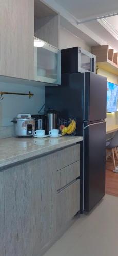 a kitchen with a stainless steel refrigerator in a kitchen at Santorini Condotel in Manila