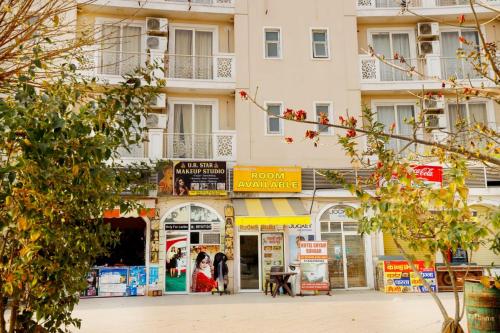 a building with shops on the side of a street at Tabtrips Bhakti Residency in Vrindāvan