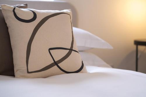 a black and white pillow sitting on top of a bed at 5 Stockland Street in Caerphilly