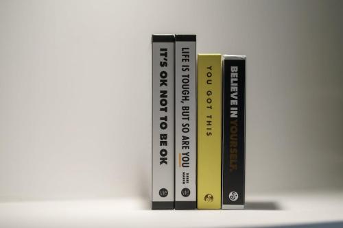 three books standing next to each other on a shelf at 5 Stockland Street in Caerphilly
