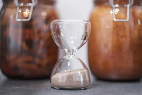 a silver hourglass sitting on a table with jars at 5 Stockland Street in Caerphilly