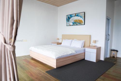 a bedroom with a bed and a window at Migu Villa By Travelink in Kejajar