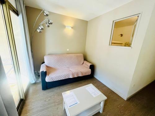 une petite pièce avec un lit et une table dans l'établissement Le vallon du Roi, à Sanary-sur-Mer