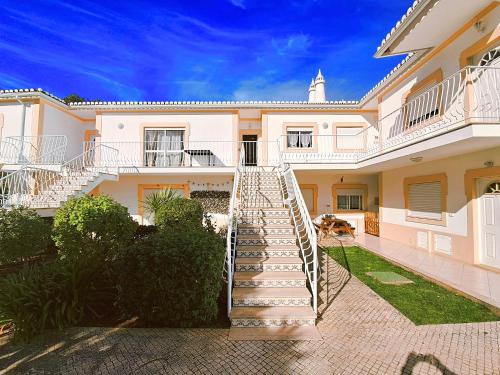 a staircase leading up to a large house at Apartamento Oásis Parque 2 in Portimão