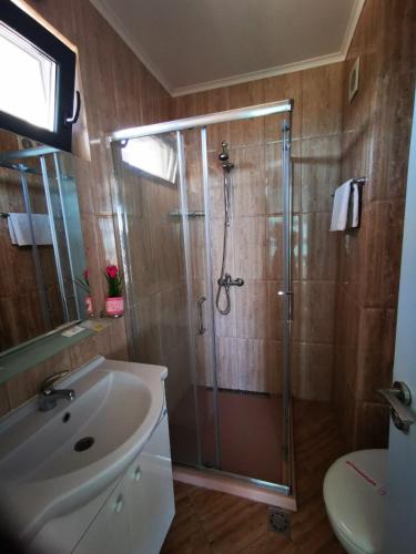 a bathroom with a shower and a sink at Azur Apartments in Sozopol