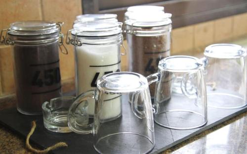 a counter with several glass jars on a table at אחוזות החרמון in Mas'ade