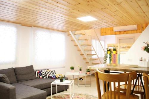 a living room with a couch and a staircase at אחוזות החרמון in Mas'ade