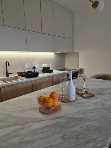 a kitchen with a bowl of oranges on a table at Knezev Park Apartment in Novi Sad