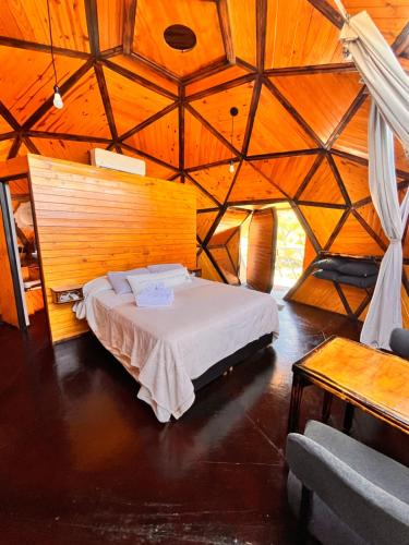 a bedroom with a bed in a large room at Domos Zen San Luis in Estancia Grande