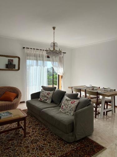 a living room with a couch and a table at Lovely 2 bedroom apartment 100m from the beach in Vila do Conde