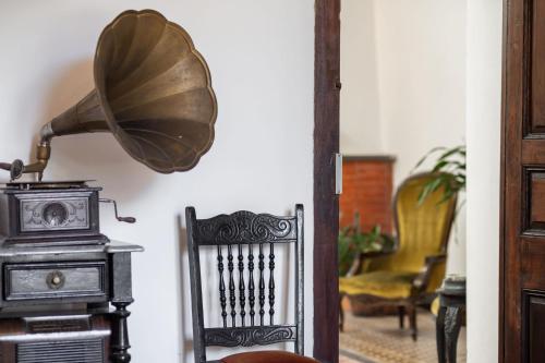 a room with a chair and a lamp at Casa en el Casco Historico con Vista al Rio in Colonia del Sacramento