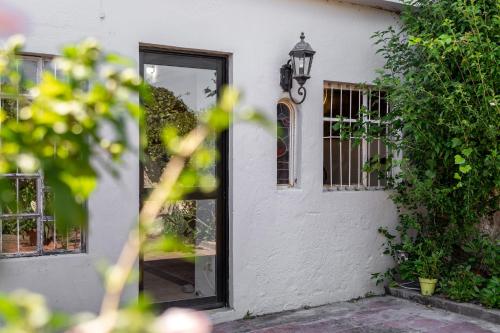 a door of a white house with a window at Casa en el Casco Historico con Vista al Rio in Colonia del Sacramento
