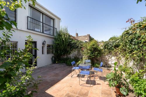a patio with a table and chairs in front of a building at Casa en el Casco Historico con Vista al Rio in Colonia del Sacramento