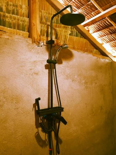 a lamp hanging on a wall in a room at Seaside Camp Bucana in El Nido