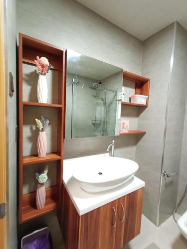 a bathroom with a sink and a mirror at B&M Rental- Antara in San Isidro