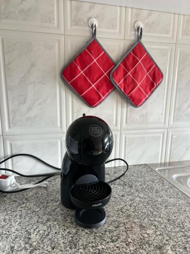 a blow dryer sitting on a counter with two wallets at Lovely 2 bedroom apartment 100m from the beach in Vila do Conde
