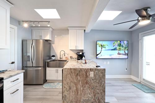 a kitchen with a refrigerator and a counter top at The Inn on Siesta Key in Siesta Key