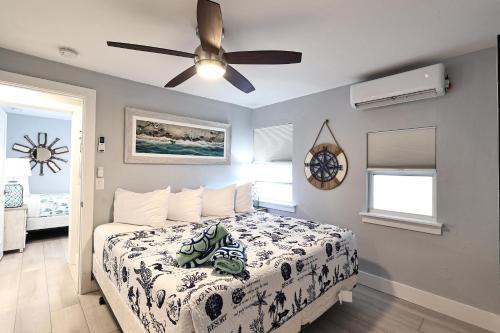 a bedroom with a bed and a ceiling fan at The Inn on Siesta Key in Siesta Key