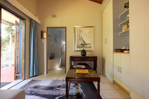 a living room with a table and a couch at Whalesong Guest House in St Lucia