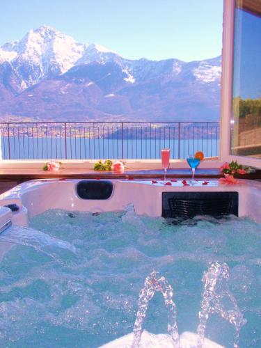 a hot tub with a view of the mountains at Residence Le Azalee & SPA in Vercana