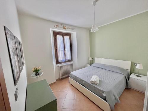 a small bedroom with a bed and a window at La Casa di Agnese in San Benedetto Val di Sambro