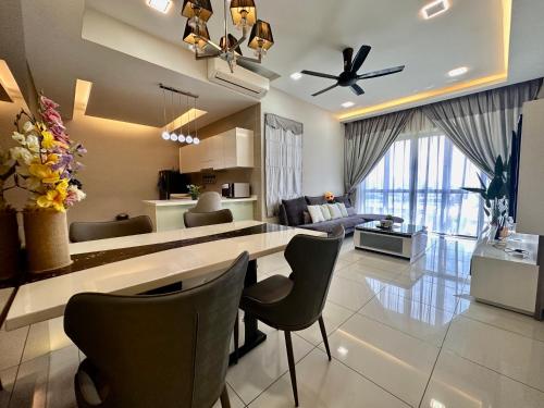 a kitchen and living room with a table and chairs at Takuro Homestay in Petaling Jaya