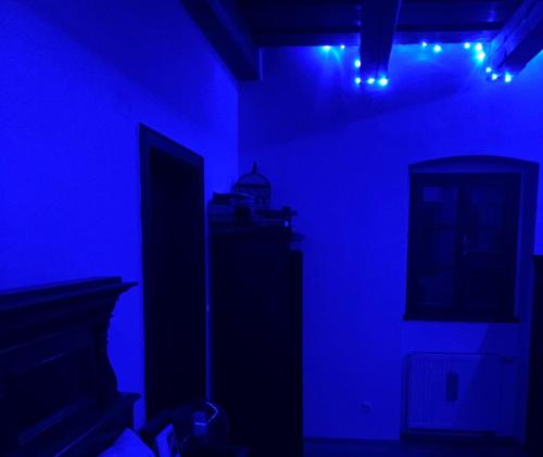 a dark room with blue lights and a television at Prague Romantic Apartment near Charles Bridge in Prague