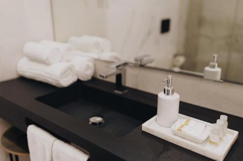 a bathroom counter with a sink and a mirror at appartamento lussuoso sul porto di Cagliari in Cagliari
