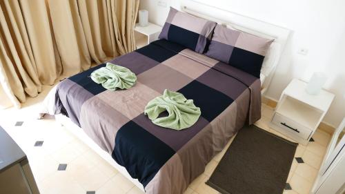 a bedroom with a bed with two towels on it at Villa Tremoulet Essaouira in Essaouira