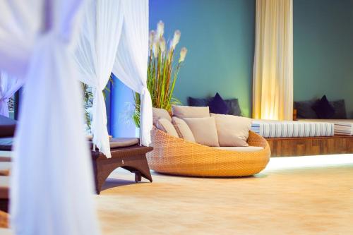 a living room with a chair and a couch at Göbel´s Vital Hotel Bad Sachsa in Bad Sachsa