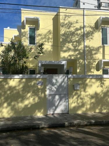 a white fence in front of a building at Villa Petrea in San Juan