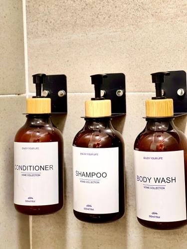 a group of three bottles of honey on a wall at HOTEL 9.5 SAN FERNANDO in Cali