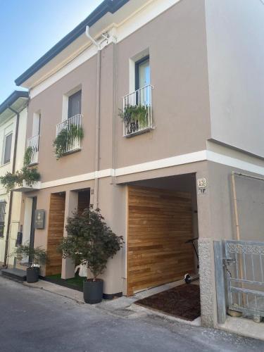 a building with a garage with a wooden door at ca' squero911 luxury rooms in Cesenatico
