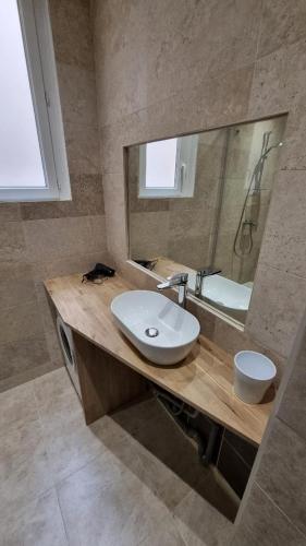 une salle de bain avec un lavabo et un miroir dans l'établissement le mauritania, à Sainte-Maxime