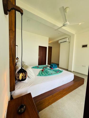 a bedroom with a large white bed with at Villa LA Kurumba in Ambalangoda