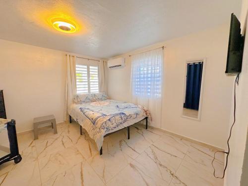 a bedroom with a bed and a television in it at Casa Soluna in Arecibo