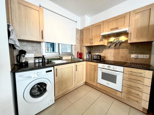 a kitchen with a washer and dryer at STAY Chromata Lagoon Apartment in Protaras