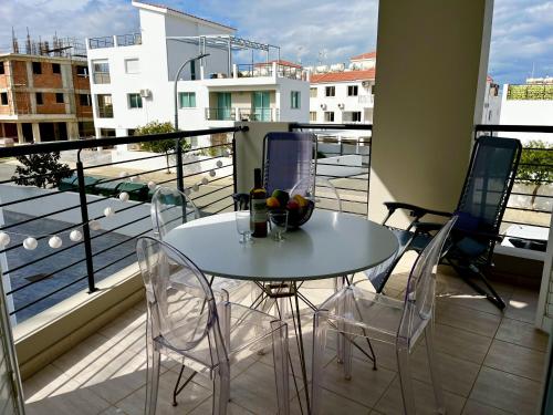 a table and chairs on a balcony with a view at STAY Chromata Lagoon Apartment in Protaras