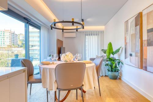 a dining room with a table and chairs at Funchal Acqua Blue 8E, a Home in Madeira in Funchal