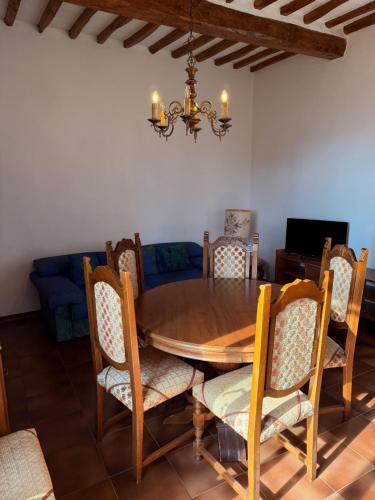 a dining room with a wooden table and chairs at Ciliegia di Lari - Attico in Lari