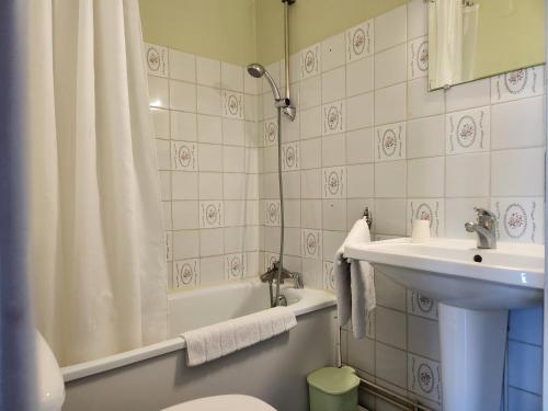 a bathroom with a sink and a toilet and a shower at Hôtel de Vendée Restaurant Les2M in Fontenay-le-Comte