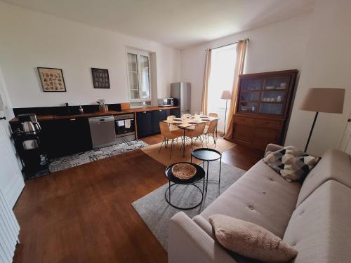 a living room with a couch and a table at Domaine et Manoir du Picaud in Monestier