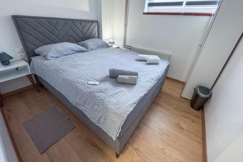 a bedroom with a bed with two towels on it at Apartman Marinero in Kutjevo