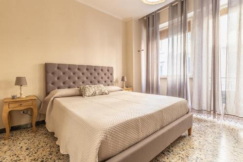 a bedroom with a large bed and a window at L'Erika in Città in Livorno